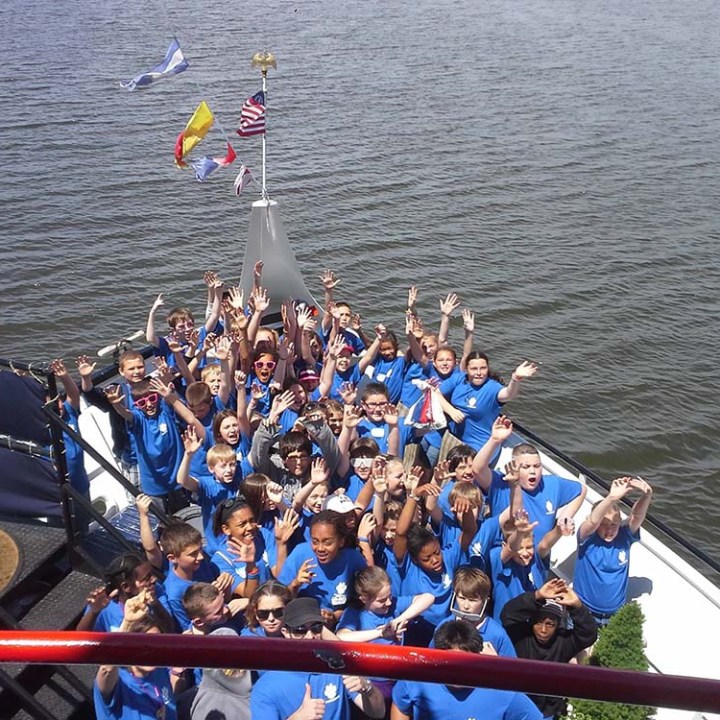 a group of people rowing a boat in a body of water