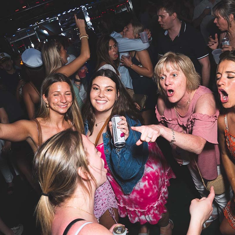 a group of people standing in front of a crowd posing for the camera