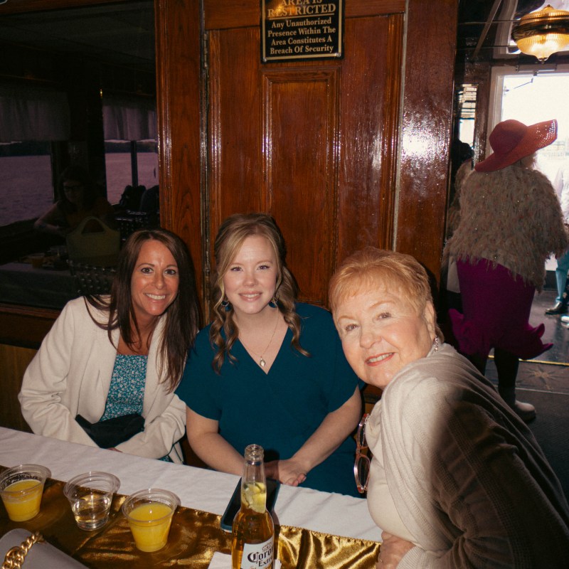 a group of people sitting at a table posing for the camera