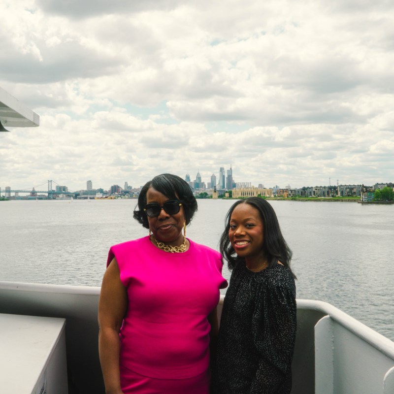 Brenda Dziadaszek standing in front of a boat next to a body of water