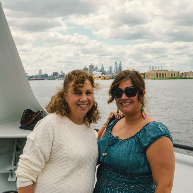 a man and a woman standing in front of water