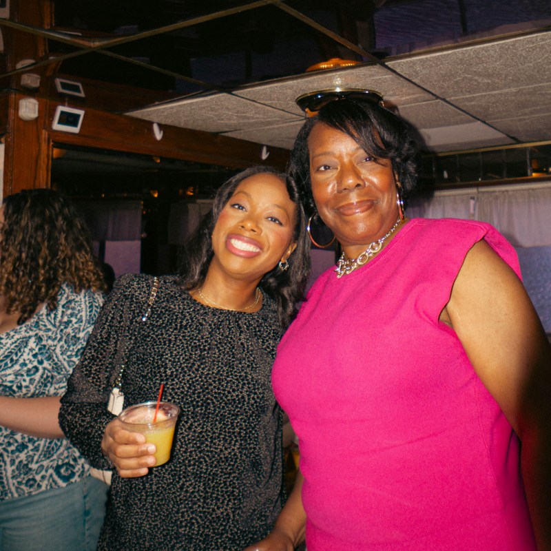 a person standing in front of a group of people posing for the camera