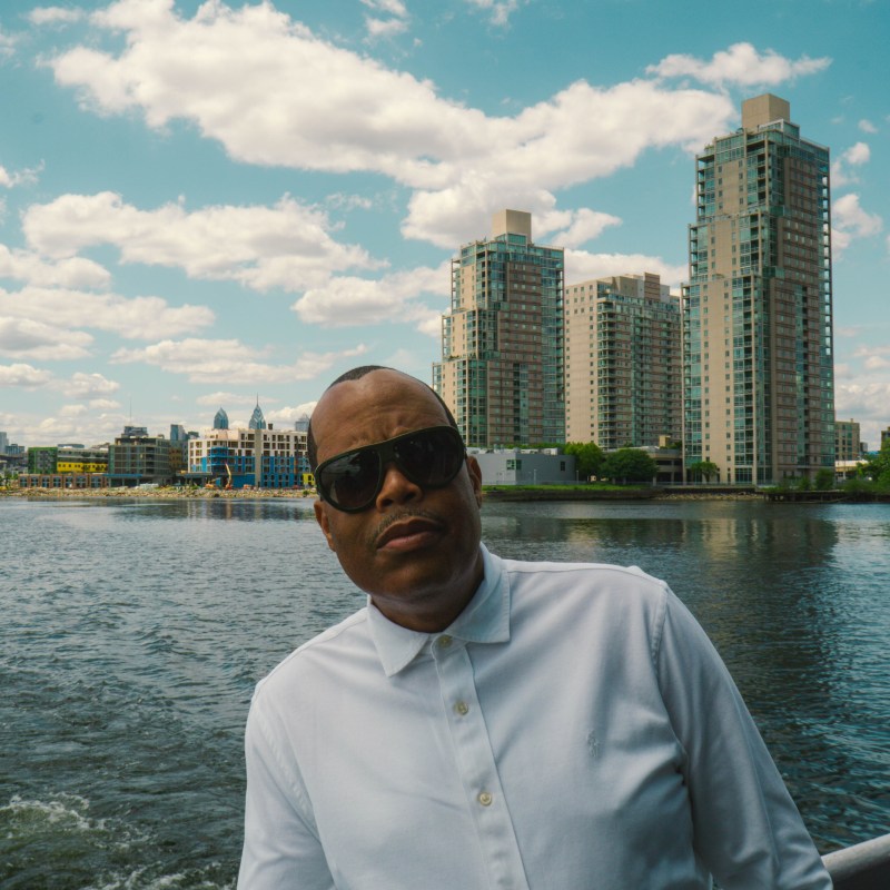 a man standing in front of a body of water